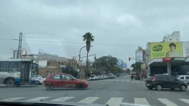 Persona abrigada frente a un termómetro que muestra bajas temperaturas