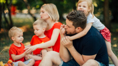 Padres y madres con sus hijos jugando en un parque
