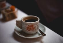 Taza de café humeante sobre mesa, símbolo de la costumbre cordobesa