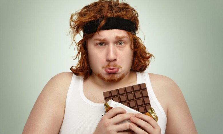 Persona olfateando chocolate antes de hacer extensiones de piernas en el gimnasio